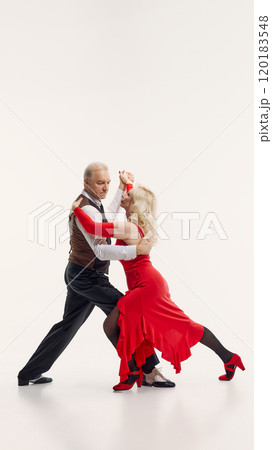 Tango aesthetic through years. Elderly beautiful woman and handsome senior man, couple dancing tango isolated on white background. Tango aesthetic through years. Elderly beautiful woman and handsome senior man, couple dancing tango isolated on white background. 120183548