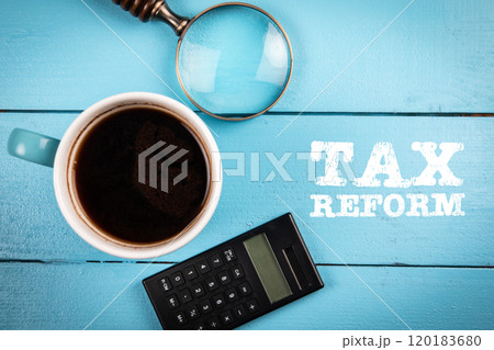 Tax Reform. Coffee mug, magnifying glass and calculator on a wooden background 120183680