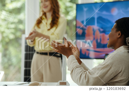 Woman Applauding To Colleague At Presentation Woman Applauding To Colleague At Presentation 120183692