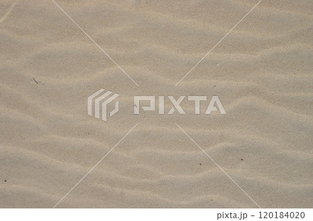 View from above, diagonal wave direction. Wind marks on the beach sand. 120184020