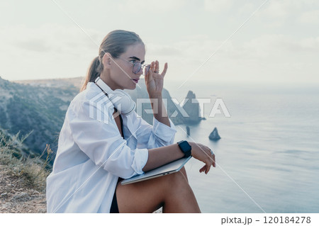 Woman, Cliff, Ocean - Woman in white shirt sitting on a cliff overlooking the ocean. 120184278