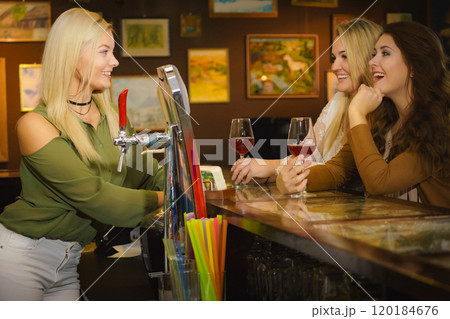 Young women in pub club at counter 120184676