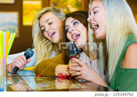 Women singing with microphone Women singing with microphone 120184702