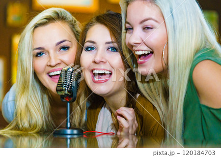 Women singing with microphone Women singing with microphone 120184703