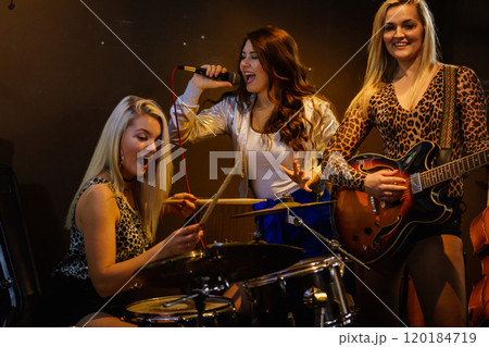 Woman singing, band playing instruments. 120184719
