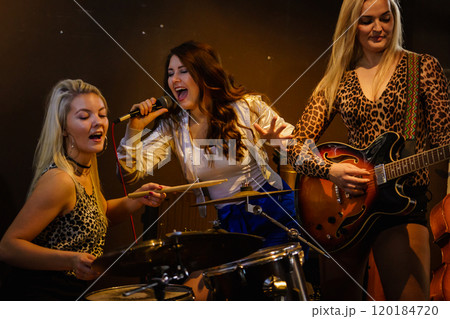 Woman singing, band playing instruments. 120184720
