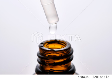 Close-up of a brown cosmetic bottle with a pipette. 120185512