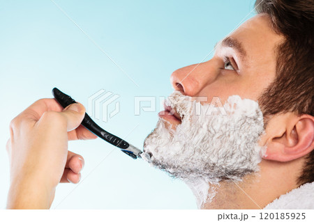Man shaving with razor face profile Man shaving with razor face profile 120185925