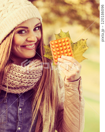 Woman with vitamins for autumn. Woman with vitamins for autumn. 120186096