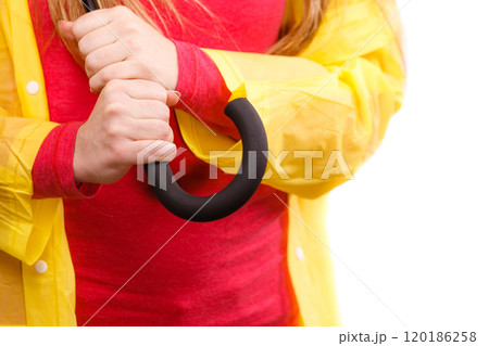 Woman wearing waterproof coat holding umbrella 120186258