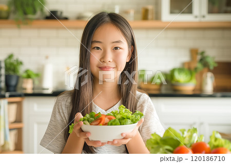 Asian girl eating salad, healthy eating concept 120186710