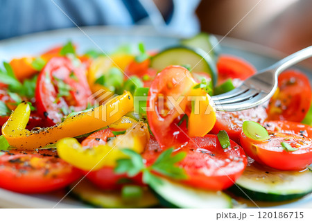Woman eating salad with fork close-up, healthy eating concept 120186715