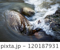 the water of the river flows around the stones 120187931