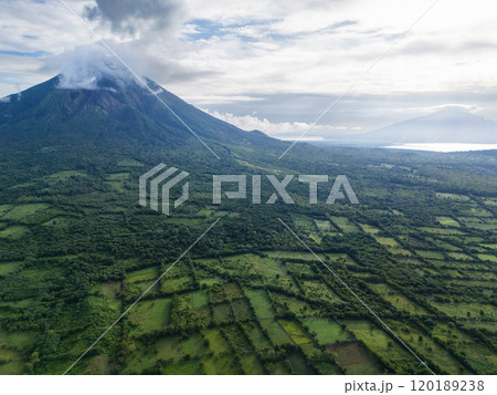 Lush landscape with volcano surrounded by greenery at dawn 120189238