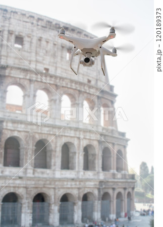 Unmanned Aircraft System Quadcopter Drone UAV In The Air Near The Colosseum In Rome. 120189373