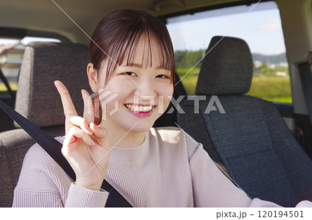 笑顔で運転をする若い女性 笑顔で運転をする若い女性 120194501