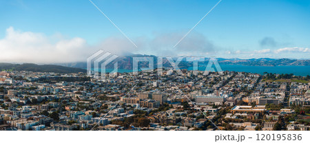 Aerial perspective of San Francisco's urban landscape, featuring the Golden Gate Bridge partially covered in fog, with Marin Headlands in the distance. Aerial perspective of San Francisco's urban landscape, featuring the Golden Gate Bridge partially covered in fog, with Marin Headlands in the distance. 120195836