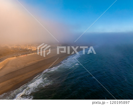 An aerial perspective of Ocean Beach in San Francisco, California, shows the Pacific Ocean, sandy beach, and fog rolling over the cityscape. An aerial perspective of Ocean Beach in San Francisco, California, shows the Pacific Ocean, sandy beach, and fog rolling over the cityscape. 120195897