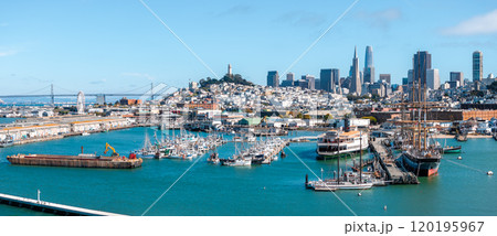 Aerial view of San Francisco featuring Coit Tower on Telegraph Hill, Bay Bridge, and skyline with Transamerica Pyramid and Salesforce Tower. 120195967