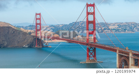 The Golden Gate Bridge's International Orange color contrasts with blue waters and Marin County hills, capturing its iconic structure in clear detail. The Golden Gate Bridge's International Orange color contrasts with blue waters and Marin County hills, capturing its iconic structure in clear detail. 120195974