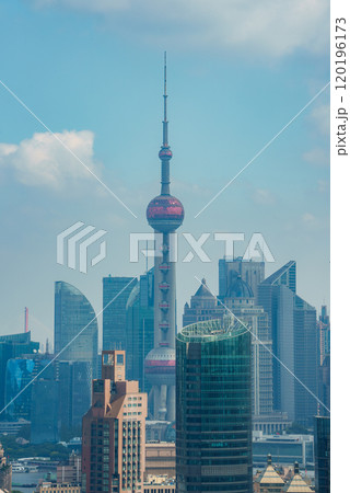 The image displays Shanghai's skyline with the Oriental Pearl Tower, Jin Mao Tower, and Shanghai World Financial Center under a clear blue sky. 120196173