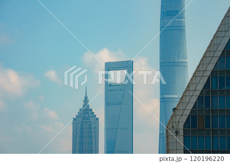 View of Shanghai's skyline featuring Jin Mao Tower, Shanghai World Financial Center, and Shanghai Tower against a clear blue sky. View of Shanghai's skyline featuring Jin Mao Tower, Shanghai World Financial Center, and Shanghai Tower against a clear blue sky. 120196220