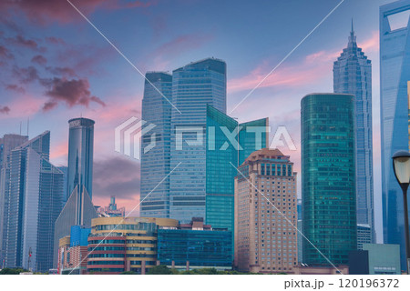 The image displays Shanghai's Pudong district skyline, highlighting the Shanghai World Financial Center and Jin Mao Tower against a pink and blue sky. 120196372