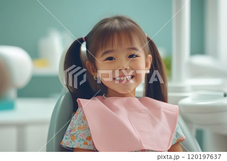 Cheerful young girl smiling during a dental checkup, sitting in the dentists chair. Cheerful young girl smiling during a dental checkup, sitting in the dentists chair. 120197637
