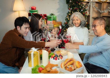 Dinner and Family holiday celebrating, together at Merry Christmas and  New Year. in a cozy festive home setting. 120200943