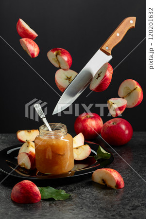 Apple jam and kitchen knife with red fresh apple slices. Apple jam and kitchen knife with red fresh apple slices. 120201632