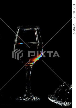 Wineglass with red wine on a black background in the dark. Illustration. 120201701
