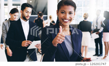 Lets get this show on the road. Cropped portrait of an attractive young businesswoman walking with her colleagues and showing a thumbs up while in the office. 120201747