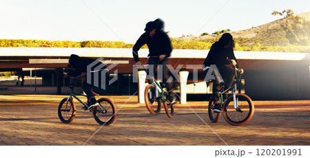 Landing the perfect trick. Full length shot of a young male BMX rider doing tricks around the city. 120201991