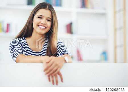 Happy and relaxed at home. Portrait of an attractive young woman relaxing at home. 120202083