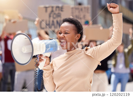 Youll never stop us. Shot of a young woman shouting through a loudhailer at a protest. Youll never stop us. Shot of a young woman shouting through a loudhailer at a protest. 120202119