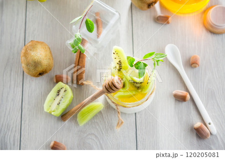 Homemade yogurt in a glass jar with honey, kiwi, nuts. 120205081