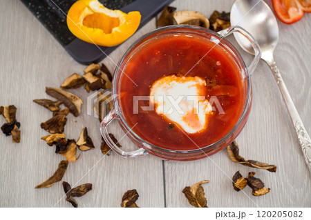 Lenten borscht with dried mushrooms and vegetables, on a light wooden table Lenten borscht with dried mushrooms and vegetables, on a light wooden table 120205082