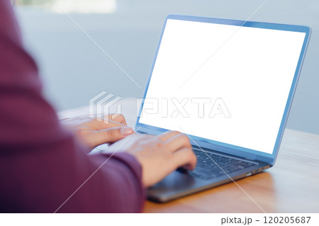 Mockup image of adult man using and typing on laptop on table in the cafe. 120205687