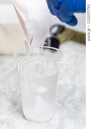 Pouring Glucose Powder into Water for Glucose Tolerance Test Pouring Glucose Powder into Water for Glucose Tolerance Test 120205793
