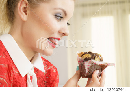 Attractive woman holds cake in hand Attractive woman holds cake in hand 120207444