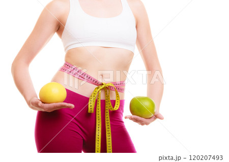 Diet. Fit girl with measure tapes citrus fruits 120207493
