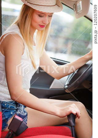 driver hand shifting the gear stick 120207609