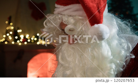 Santa Claus Read The Letters Near The Fireplace In The Office 120207653