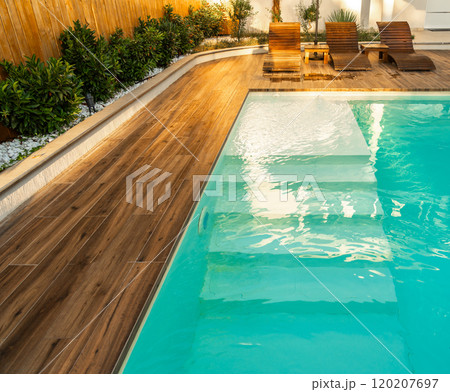 Swimming pool entrance steps with clean blue water at modern villa Swimming pool entrance steps with clean blue water at modern villa 120207697
