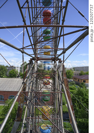 View of the Ferris wheel frame with colorful booths View of the Ferris wheel frame with colorful booths 120207737