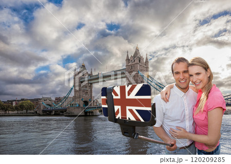 Couple in love taking a selfie portrait in front of Tower Bridge on their way around London, England, UK Couple in love taking a selfie portrait in front of Tower Bridge on their way around London, England, UK 120209285