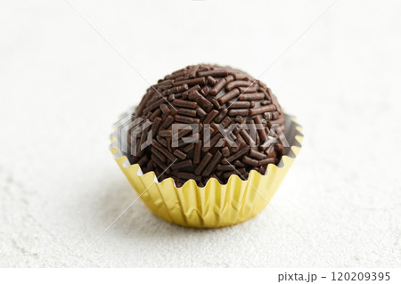 Typical Brazilian sweet brigadeiro. One chocolate candy on a white background Typical Brazilian sweet brigadeiro. One chocolate candy on a white background 120209395