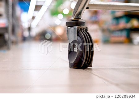 CloseUp of Shopping Cart Wheels in Grocery Store, showing convenience and ease of shopping 120209934