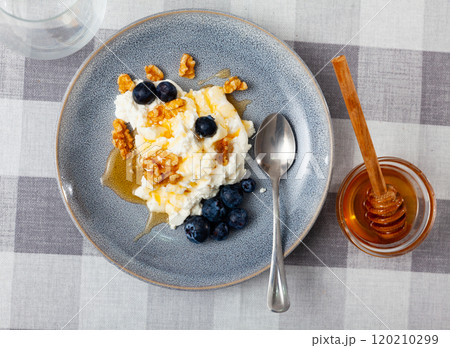 Farm cottage cheese filled with large amount of honey with walnut and blueberry. 120210299