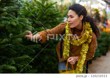 Portrait of asian woman buying Christmas tree at Christmas market Portrait of asian woman buying Christmas tree at Christmas market 120210313